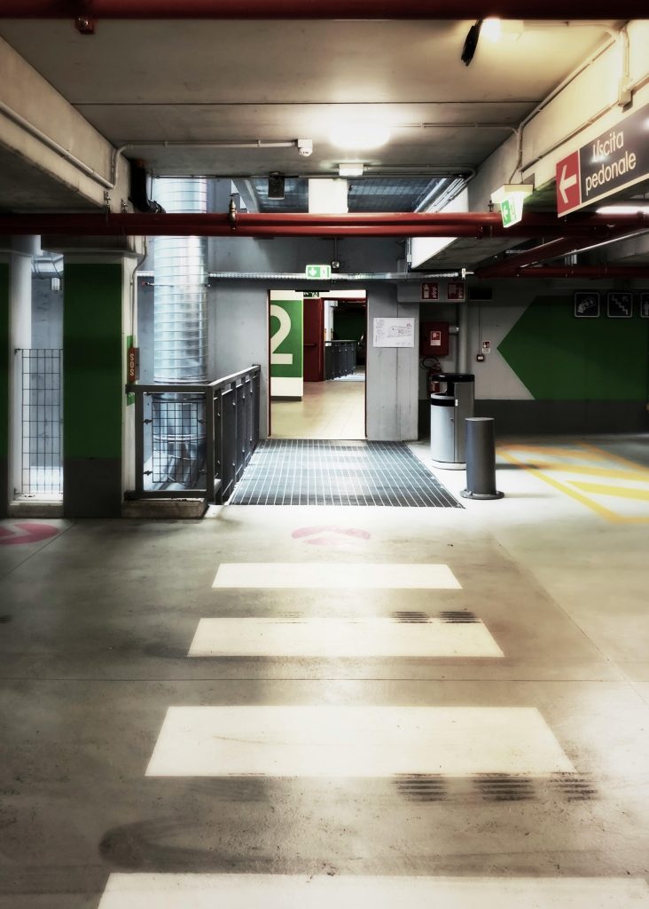 Contemporary indoor parking area with clear paths and signage.